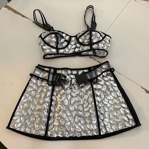 Clear plastic skirt and top with large gems and black trim. Festival / rave fit